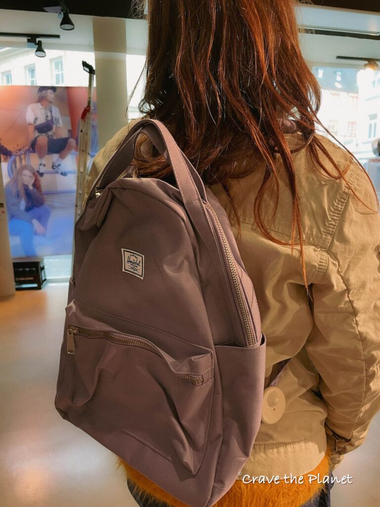 woman wearing herschel backpack
