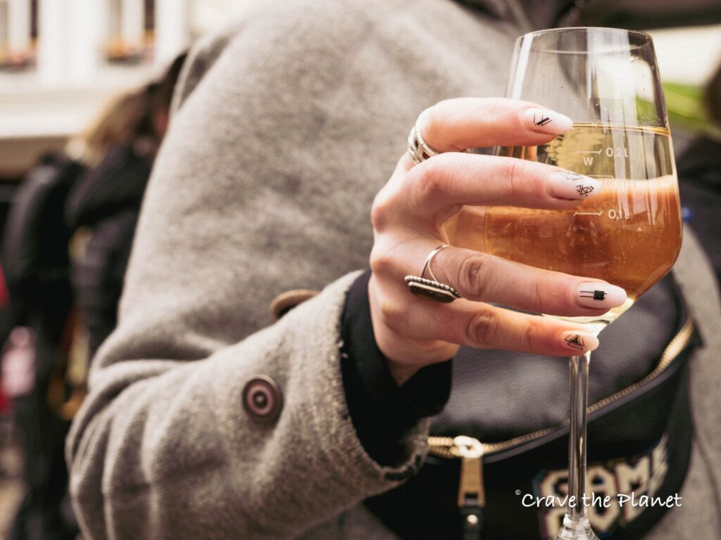 woman drinking wine in trier close up hand
