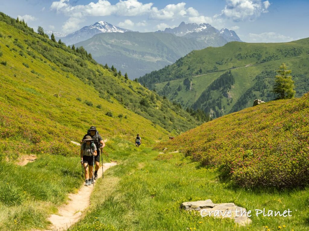 married couple hiking the tour du mont blanc with big mountains
