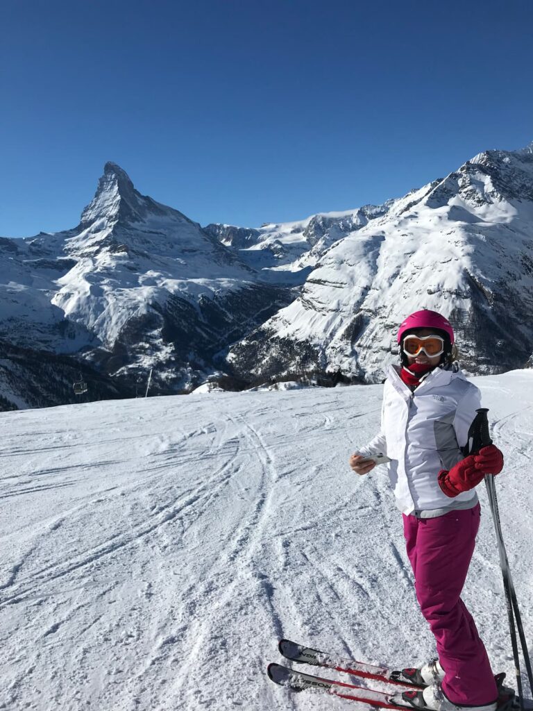 woman skiing in italy and switzerland under matterhorn