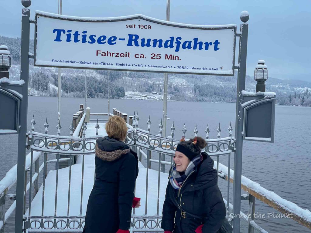 Two women laughing on the dock of lake titisee germany