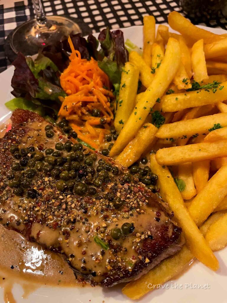 steak and french fries with salad.