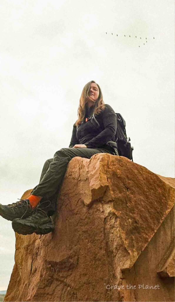woman hiker sitting on top of a rock