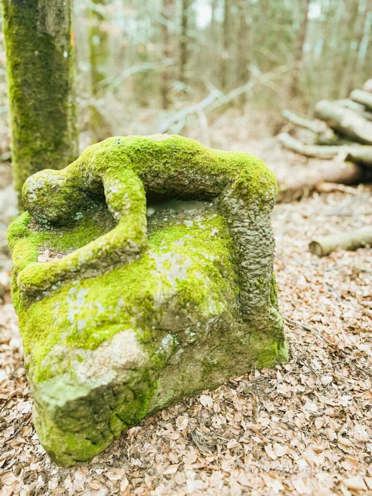 sculpture of man bending over rock near rodenbach germany